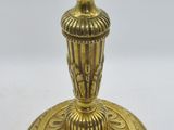 antique brass candle holder with ornate design on base