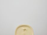 a yellow plate sitting on top of a white table