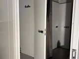 a bathroom with a shower and a bench in it
