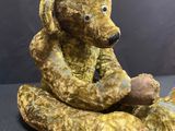 a teddy bear that is sitting on the ground