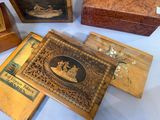 several wooden boxes with pictures of people on them on a table