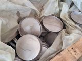 a pile of tins and a wooden ruler on the floor