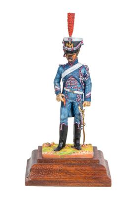 statue of a soldier in a blue uniform with a red hat on a wooden base