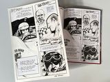 two pages from a comic book that are open on a table