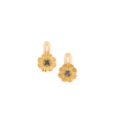 a pair of gold earrings with sapphire stones