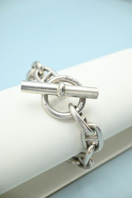 a close up of a silver ring on a white napkin