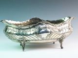an image of a silver bowl on a stand on a blue background