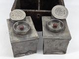 two metal containers that are sitting next to each other