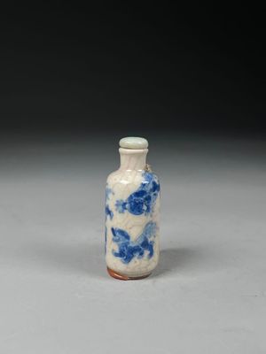 a small blue and white vase sitting on a table