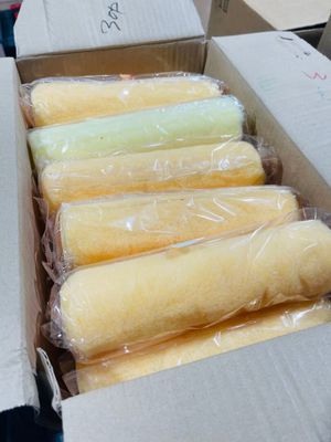 six rolls of wax in a box on a table