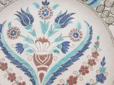 a white plate with a blue and red design on it