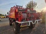 a red fire truck with a hose on the back of it