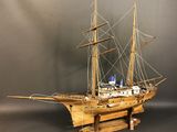 a wooden model of a ship on a stand