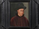 portrait of a man wearing a black hat and a red cloak
