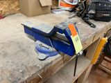 a viset on a workbench in a workshop