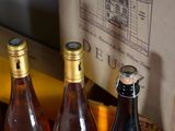 three bottles of wine sitting on a table next to a box of wine