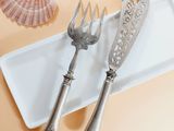 two forks and a knife sitting on a plate