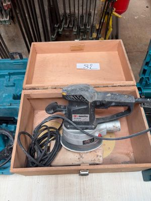 a box with a sander and other tools in it