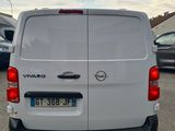 the back end of a white van parked in a parking lot