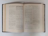 an open book on a table with a white background