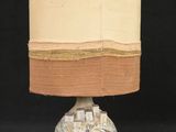 a lamp that is sitting on a table with a black background