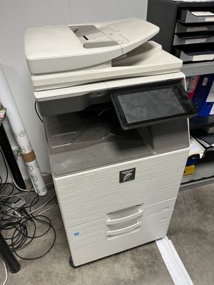 a printer that is sitting on top of a cabinet