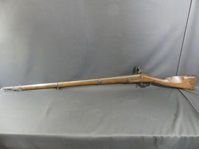 a rifle that is sitting on top of a table