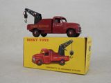 a red toy truck with a crane on top of it