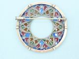 a picture of a brooch with a circular design on it