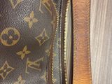 the inside of a louis vuitton bag with a zipper open