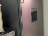 a stainless steel refrigerator in a kitchen next to a sink