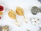 many different types of jewelry on a white surface