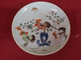 a plate with a picture of a bird and flowers on it