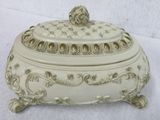a white box with a gold decoration on it
