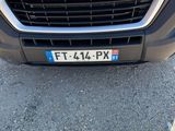 a close up of the front of a white van parked in a parking lot