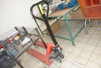 a cart that is sitting on the floor next to a table
