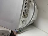 a microwave oven sitting on top of a white shelf