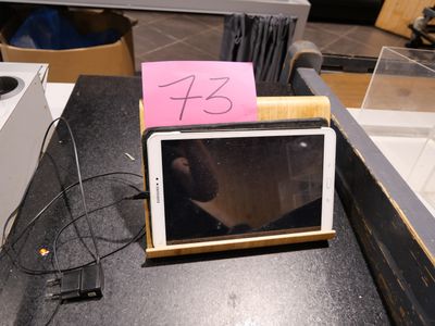 a picture of a microwave on a table with a note attached to it