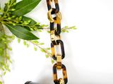 black and tortoise tortoise shell purse with gold chain