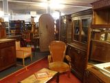 a room with a lot of antique furniture in it
