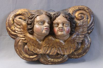 two angels that are sitting on top of each other