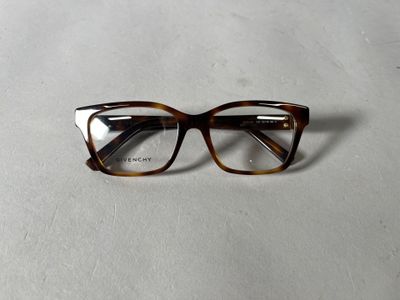 an image of a pair of glasses sitting on a white surface