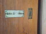 a wooden door with a sign on it that says melliez williams