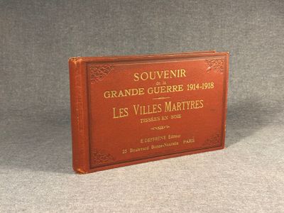 an old book sitting on top of a table on a gray surface
