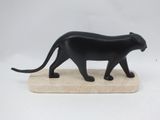 figurine of a black cat walking on a marble base