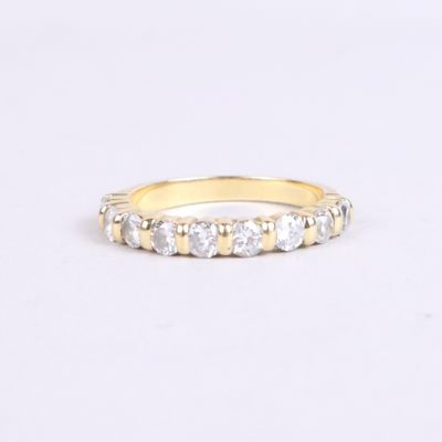a close up of a yellow gold ring with white diamonds