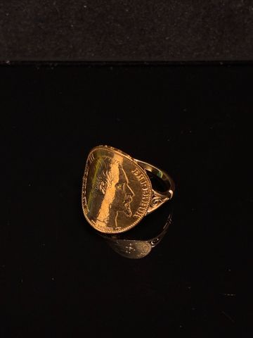Bague à décor d’une pièce de monnaie cintrée 20 francs 1854A en o...