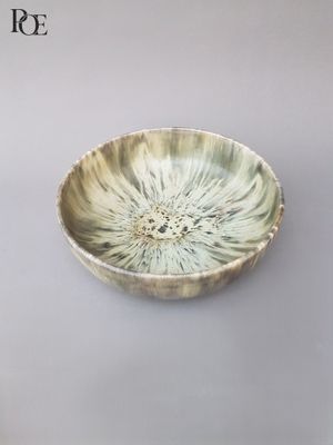 a bowl with a flower inside of it sitting on a table