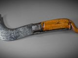 a close up of a knife with a wooden handle on a table