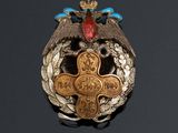 an image of a badge with an eagle and a cross on it